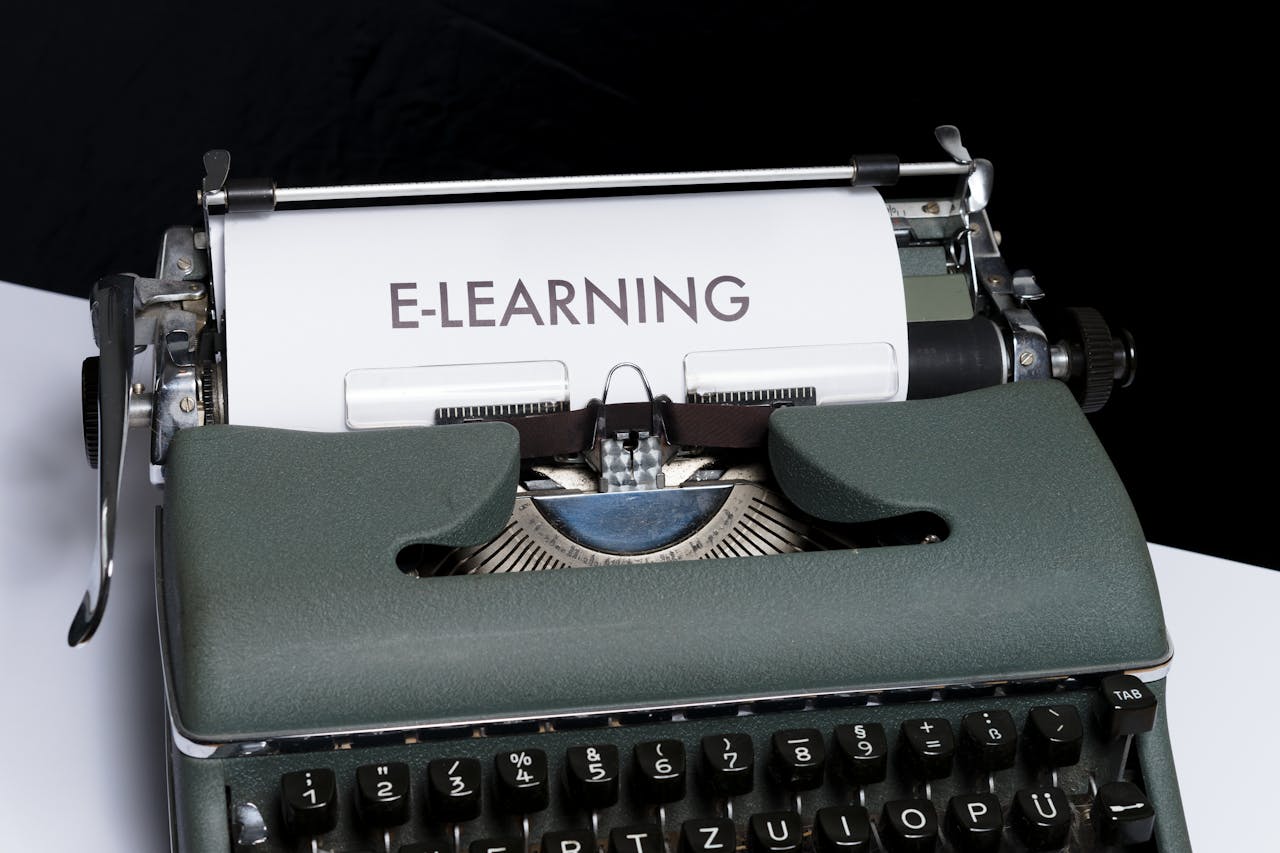Close-up of a vintage typewriter displaying the concept of e-learning on paper.